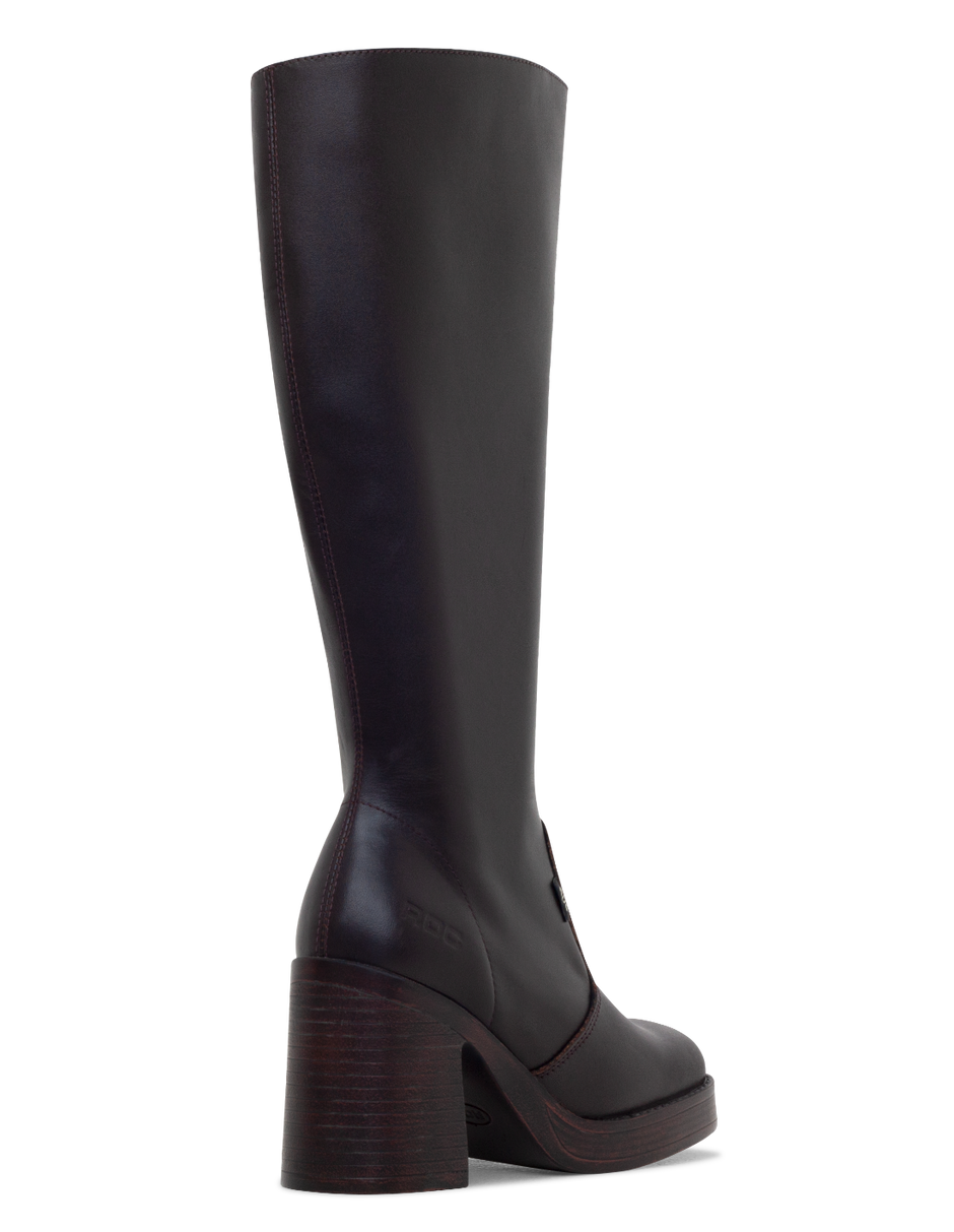 Brown knee-high boot with a platform sole on a white background